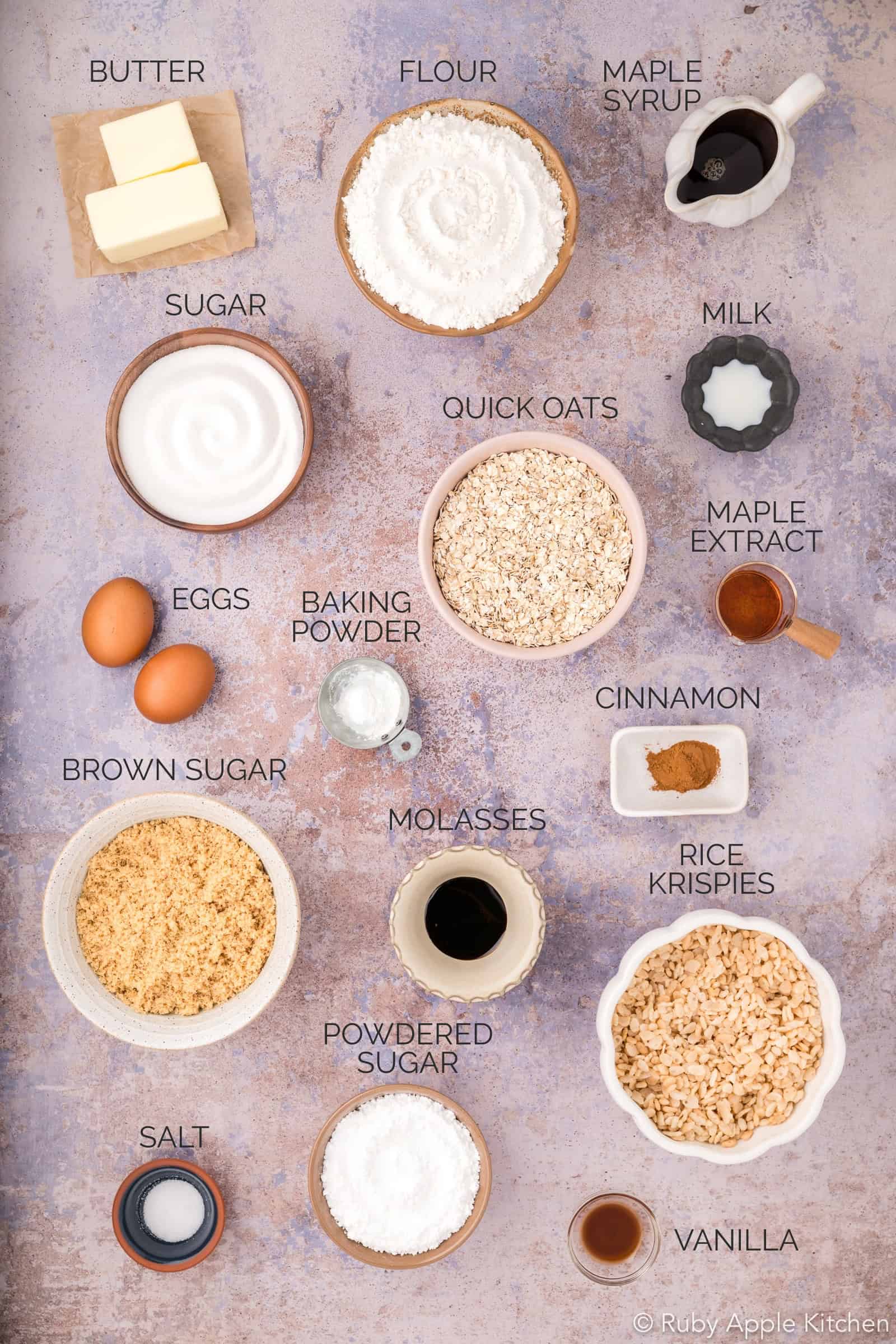Overhead view of ingredients for chewy maple oatmeal cookies, with each ingredient individually labeled.