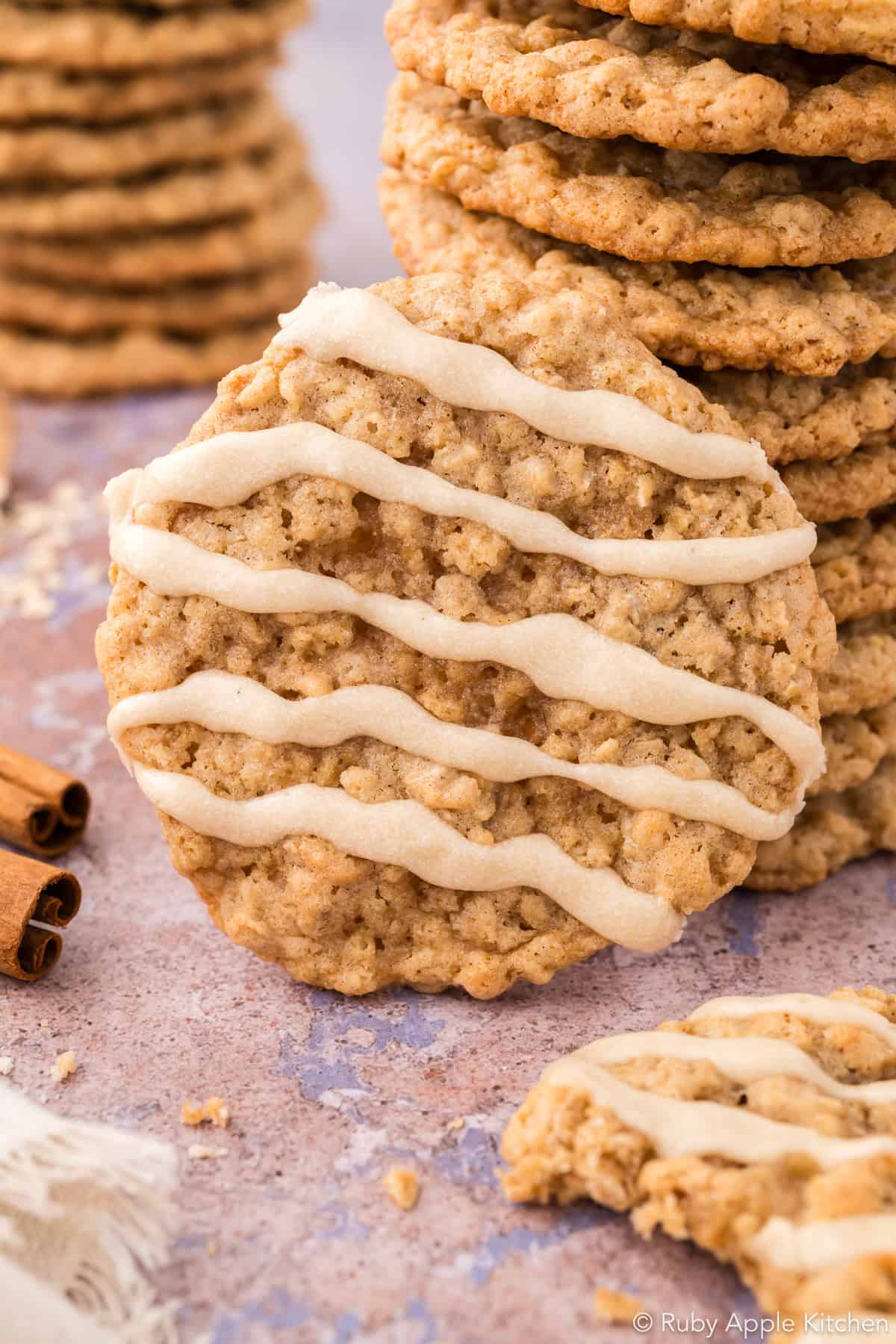 Close-up of chewy maple oatmeal cookies with Rice Krispies, topped with maple glaze.