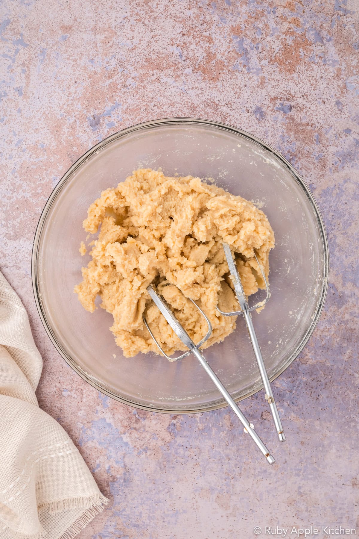 Creamed butter and sugars in a mixing bowl.
